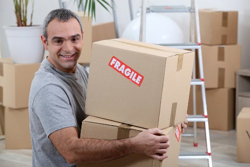 Removal team preparing furniture and moving boxes at the start of a booking