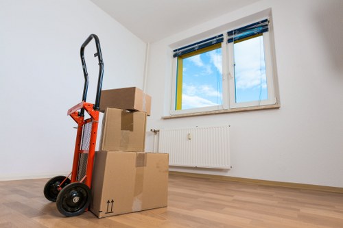 Movers carrying furniture in a residential Camdentown flat