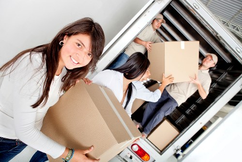 Packing and loading office equipment during a Camdentown commercial relocation