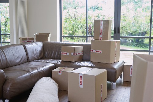 Professional movers handling furniture in a narrow Camdentown street