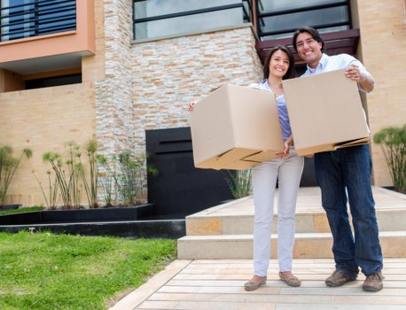 Professional movers carrying furniture through a narrow stairwell